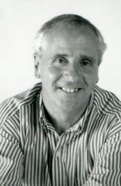 Jonathan Taylor Handspan Theatre black & white portrait of grinning man wearing striped shirt