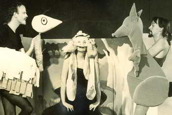 Performer in bunyip mask flanked by puppeteers with large emu and kangaroo puppets