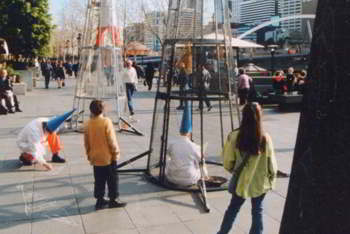 Two 4-metre cones on paved area, a Questor sitting inside one and an interested onlooker