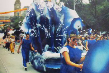 Giant hand and blue fabric waves in street parade