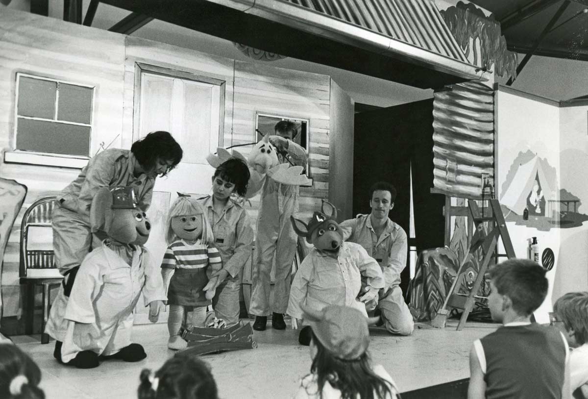 Handspan Theatre Captain Koala, kangaroo, koala, girl and bird puppets with 4 puppeteers in firefighter overalls on set of a rural Australian house verandah