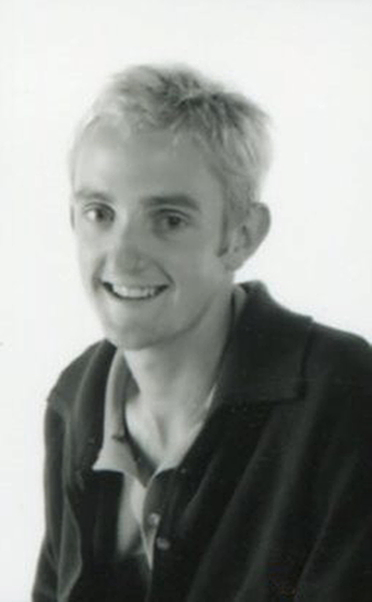 Dion teasdale, Handspan Theatre portrait of young man smiling at camera wearing open-necked shirt and jacket