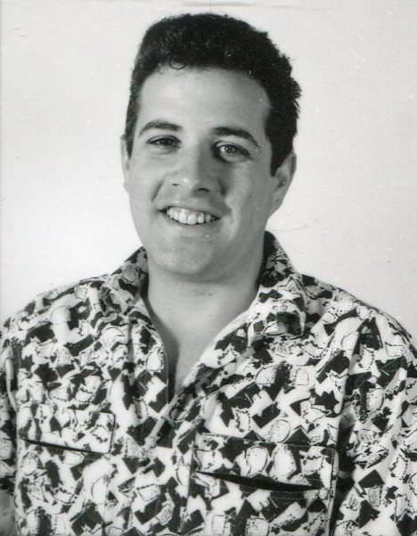 Handspan Theatre Roberto Micale portrait of a young man with dark hair wearing a patterned shirt