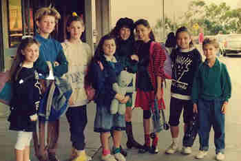 eight girls assembled at airport entrance