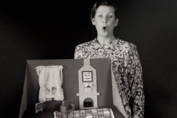 woman with cheery miniature cardboard pop-up lounge room.